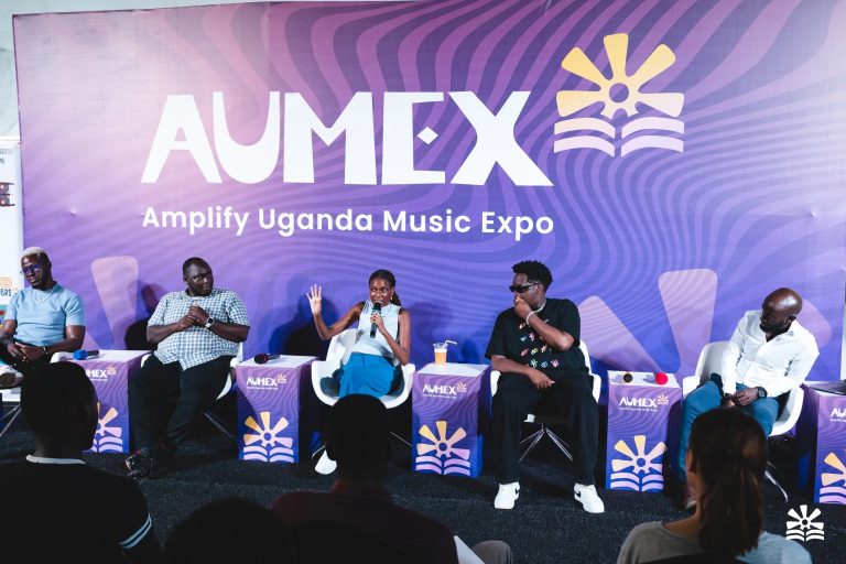 Panel discussion on stage in front of the Amplify Uganda Music Expo backdrop